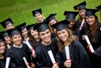 group of graduation students in the park looking happy